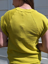 Showing back of Wesley Lime Short Sleeve Sweatshirt, rolled sleeves back completely covered. 