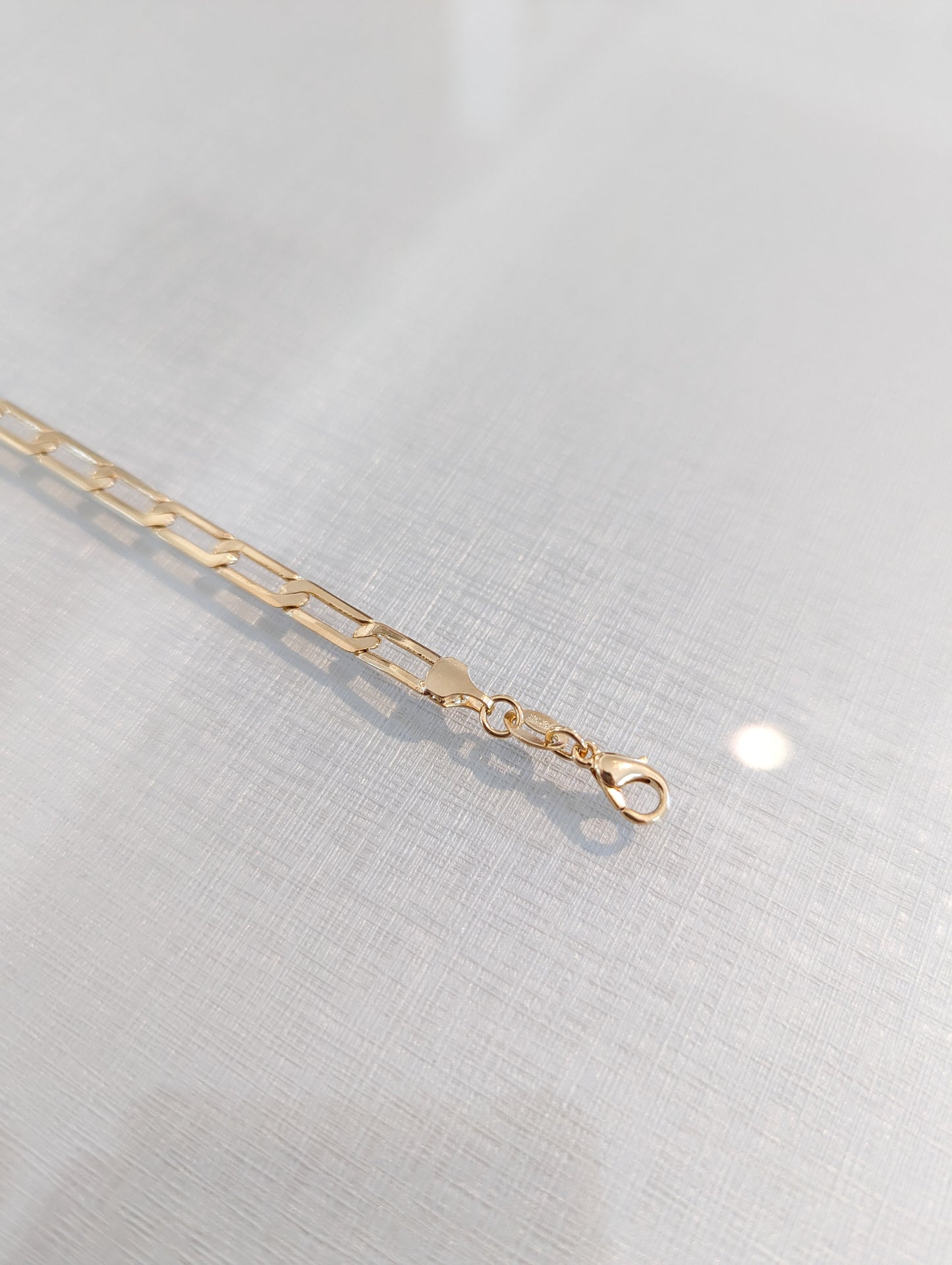 gold paperclip style bracelet with clasp