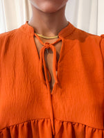 Rust v-neck tie front blouse